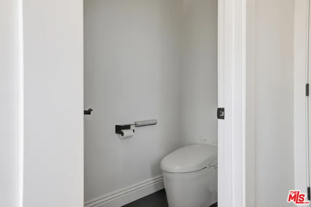 a bedroom with a bed and a potted plant