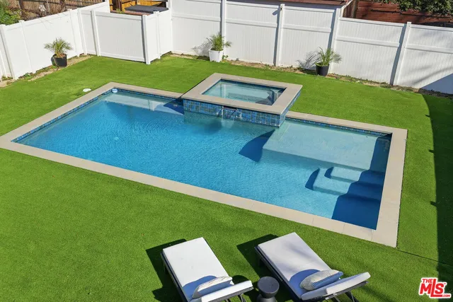 a bathroom with a white bath tub and a shower