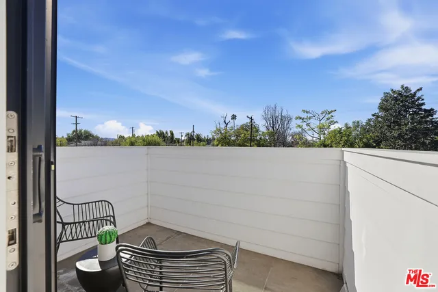 a view of a bedroom with a bed and glass door