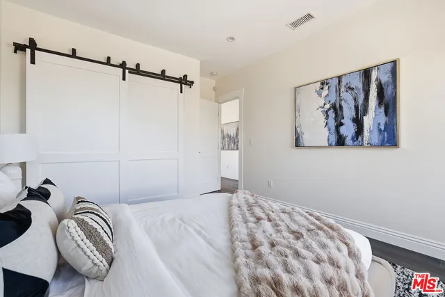 a front view of a building with large trees