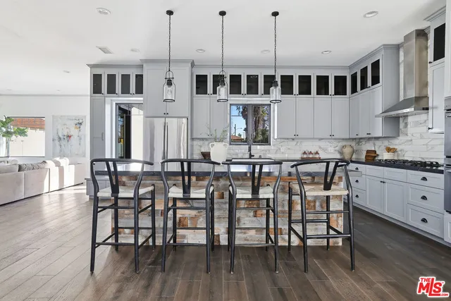 a kitchen with white cabinets and appliances