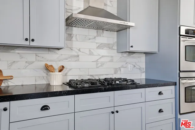 a kitchen with stainless steel appliances sink a microwave and cabinets