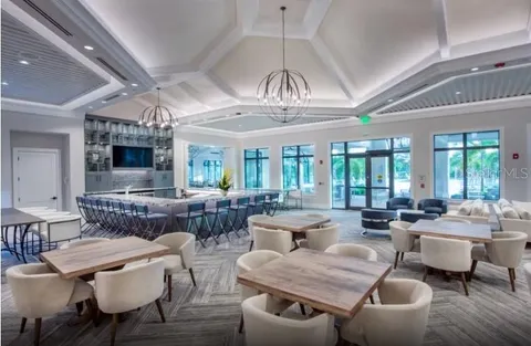 a front view of a house with a garden and a tree