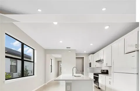 a view of kitchen with stainless steel appliances cabinets