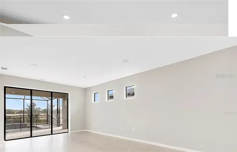 a view of kitchen with furniture and refrigerator