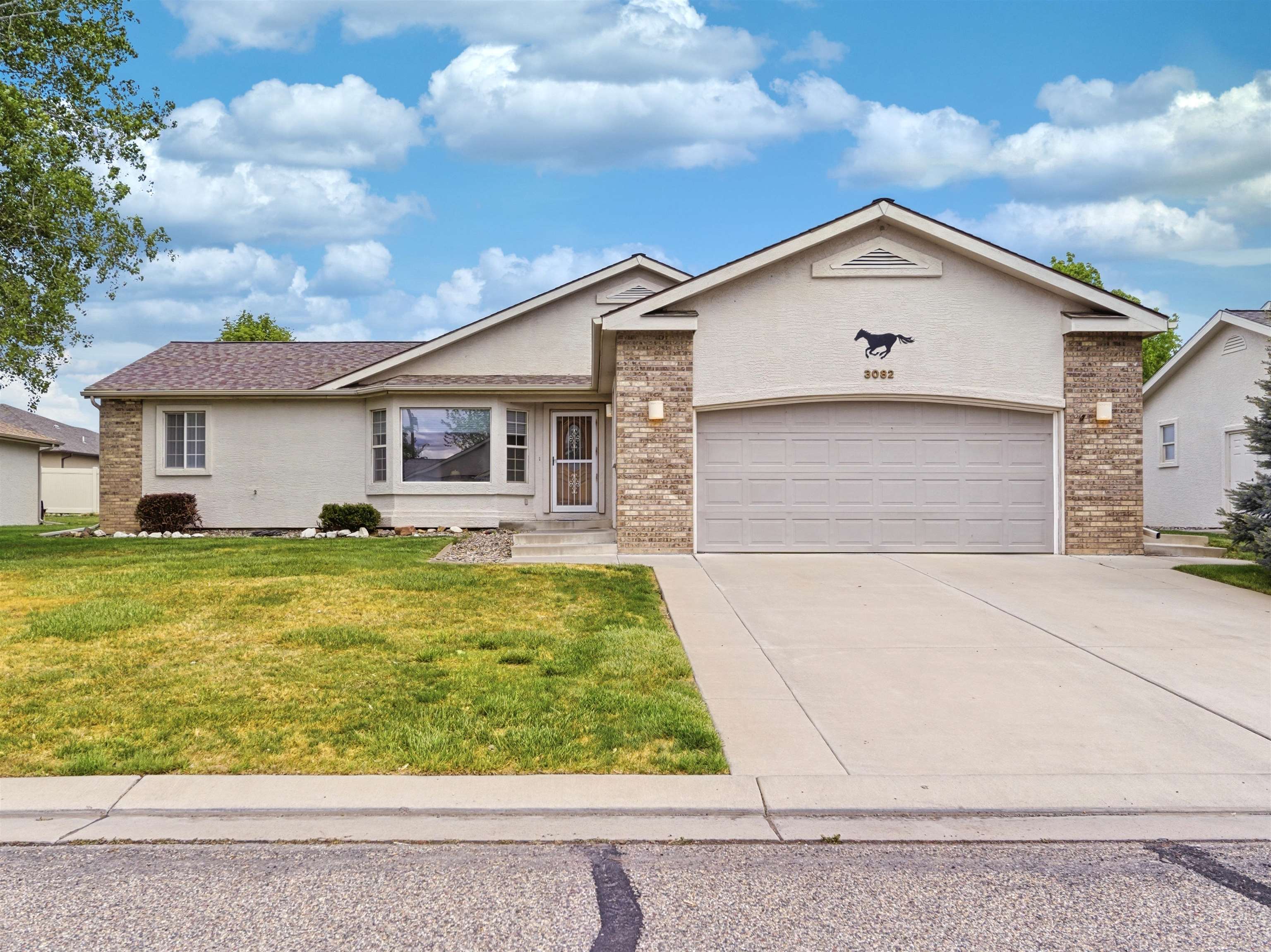 3082 Shadowbrook Court Grand Junction, CO 81504 - Photo 1 of 28 a front view of a house with garden