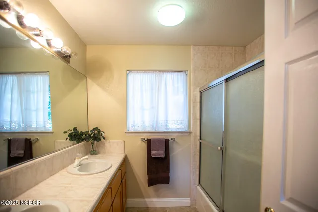 a bathroom with a tub sink and mirror