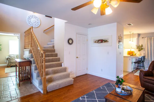 a view of an entryway with wooden floor