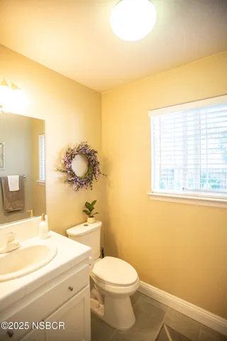 a bathroom with a sink a toilet and vanity