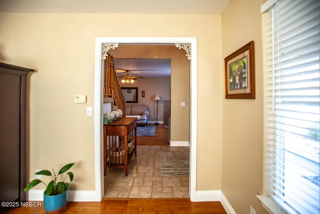 a view of a dining room with furniture and a window
