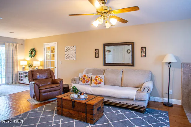 a living room with furniture a rug and a chandelier
