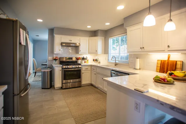 a kitchen with a sink stove and refrigerator