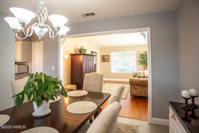 a dining room with furniture and a large window