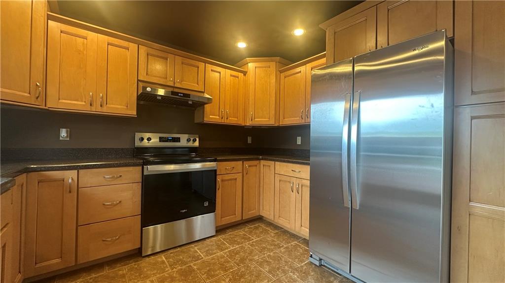 225 Larson Boulevard Rostraver Township, PA 15012 - Photo 15 of 46 a kitchen with stainless steel appliances granite countertop a refrigerator a stove and a sink with cabinets