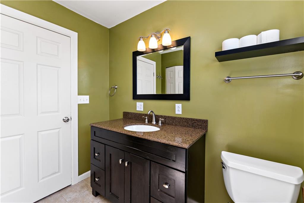 225 Larson Boulevard Rostraver Township, PA 15012 - Photo 27 of 46 a bathroom with a toilet sink and mirror
