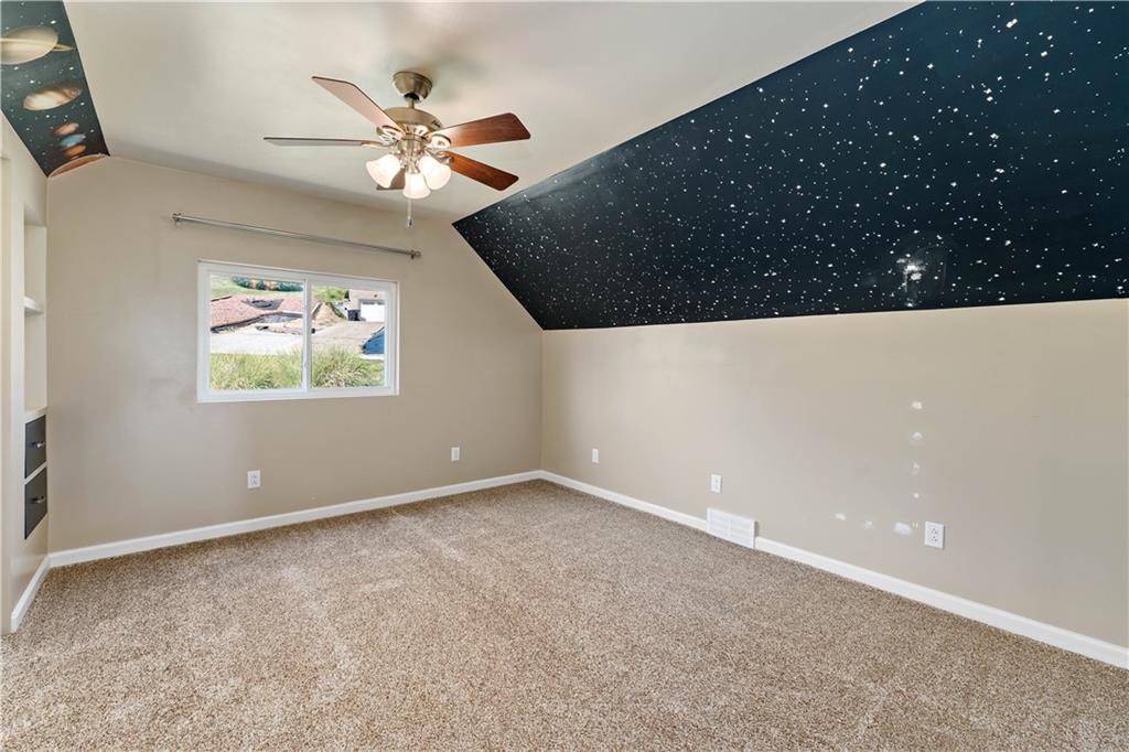 225 Larson Boulevard Rostraver Township, PA 15012 - Photo 29 of 46 en empty room with windows and ceiling fan