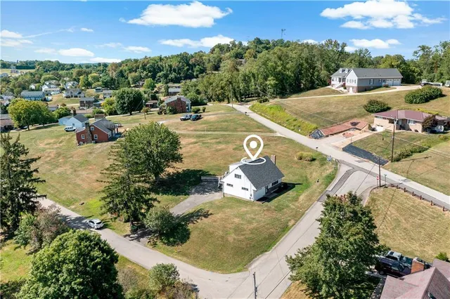 an aerial view of a house with yard swimming pool and outdoor seating