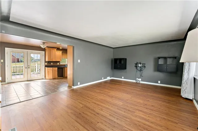 a view of empty room with wooden floor and fireplace