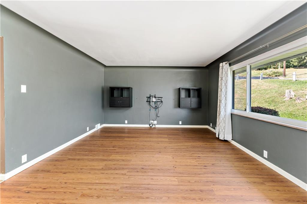 225 Larson Boulevard Rostraver Township, PA 15012 - Photo 9 of 46 a view of empty room with wooden floor and fan