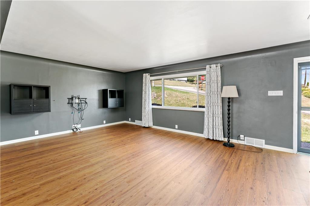 225 Larson Boulevard Rostraver Township, PA 15012 - Photo 10 of 46 a view of empty room with wooden floor and fan