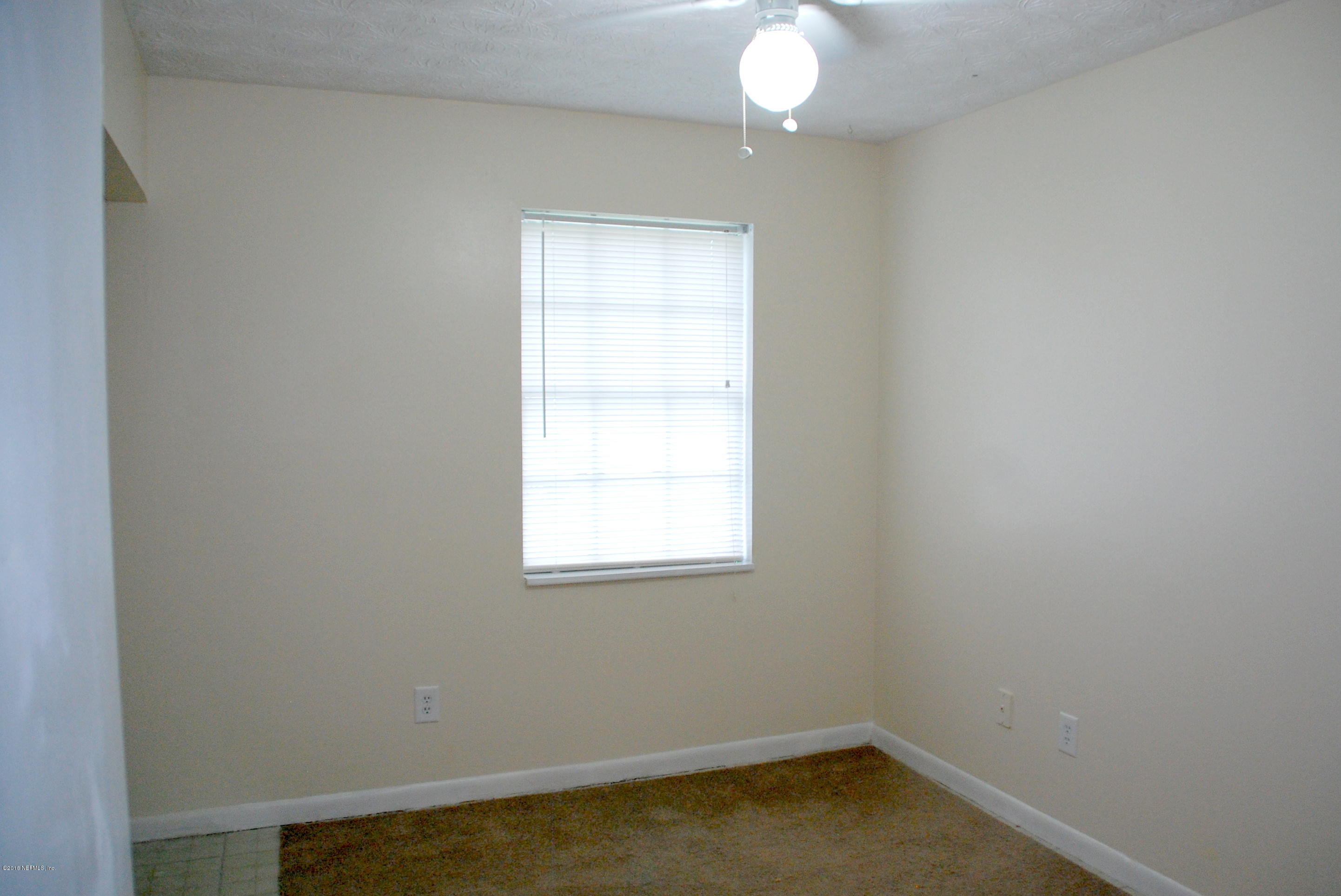 8187 Cassie Road Jacksonville, FL 32221 - Photo 6 of 13 an empty room with a window