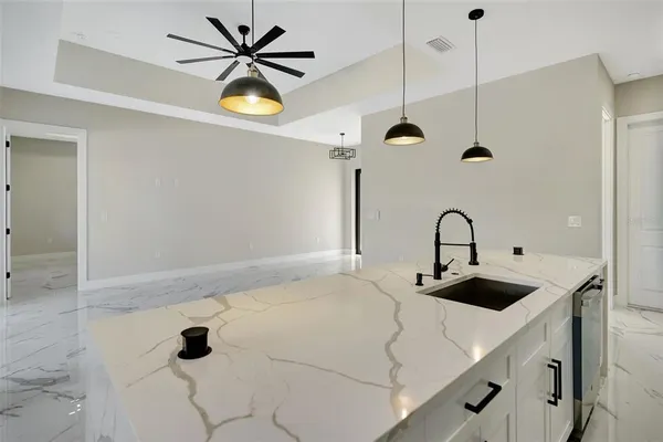 a kitchen with stainless steel appliances a refrigerator sink and stove