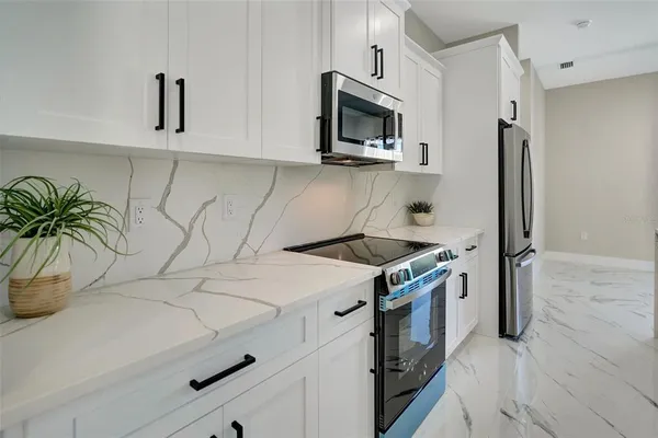 a kitchen with a sink and a chandelier