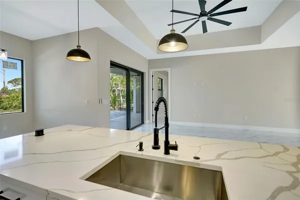 a kitchen with kitchen island a counter top space appliances and cabinets