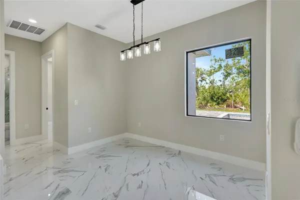 a white kitchen with cabinets and stainless steel appliances