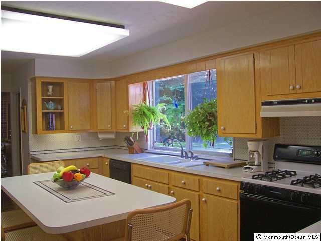 362 Elton Adelphia Road Freehold, NJ 07728 - Photo 3 of 3 a kitchen with stainless steel appliances a sink a stove and a refrigerator
