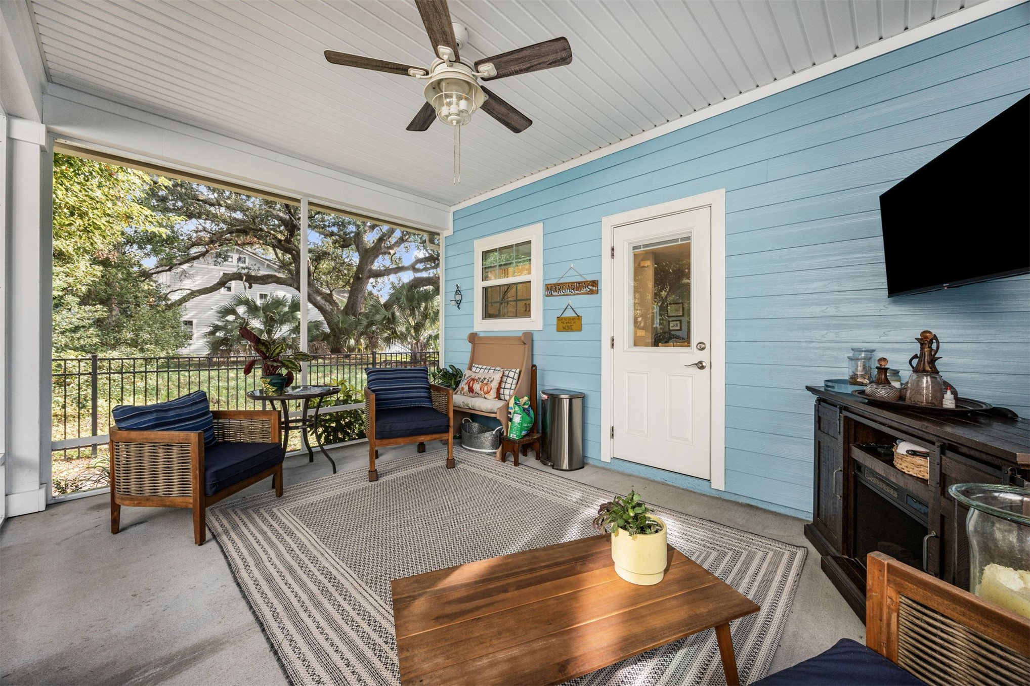 307 Elm Street Fernandina Beach, FL 32034 - Photo 24 of 35 a living room with furniture a flat screen tv and a large window