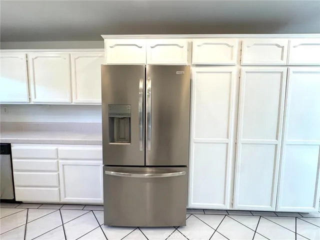 a white refrigerator freezer and a dishwasher sitting in a kitchen
