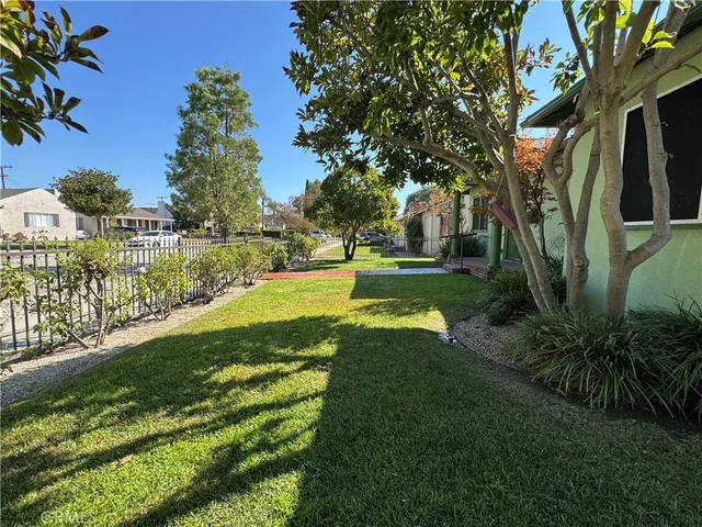 a view of yard with swimming pool and green space