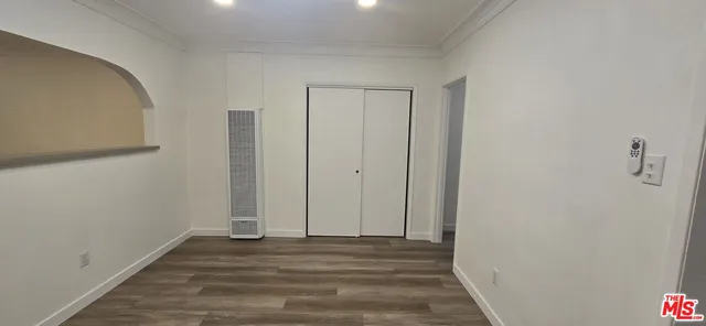 a view of a room with wooden floor