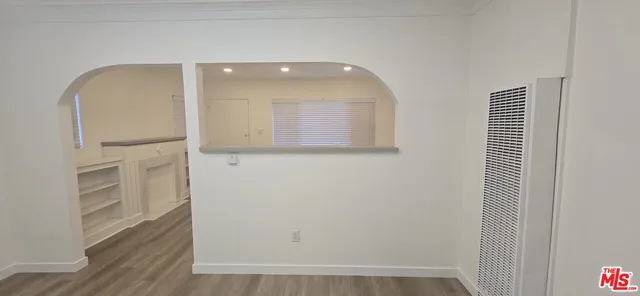 a view of a hallway with wooden floor and entryway