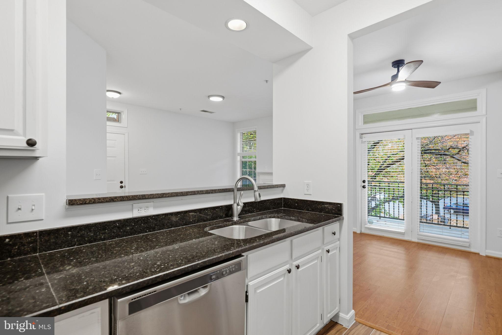1340 Garden Wall Circle, Unit 502 Reston, VA 20194 - Photo 18 of 32 a kitchen with granite countertop white cabinets and a sink