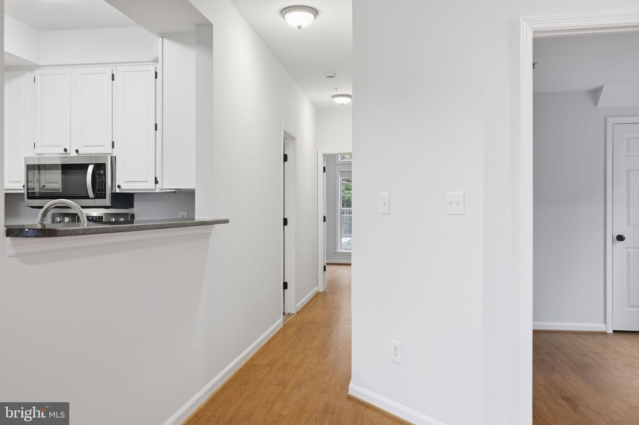 1340 Garden Wall Circle, Unit 502 Reston, VA 20194 - Photo 20 of 32 a view of a kitchen with refrigerator and a fireplace