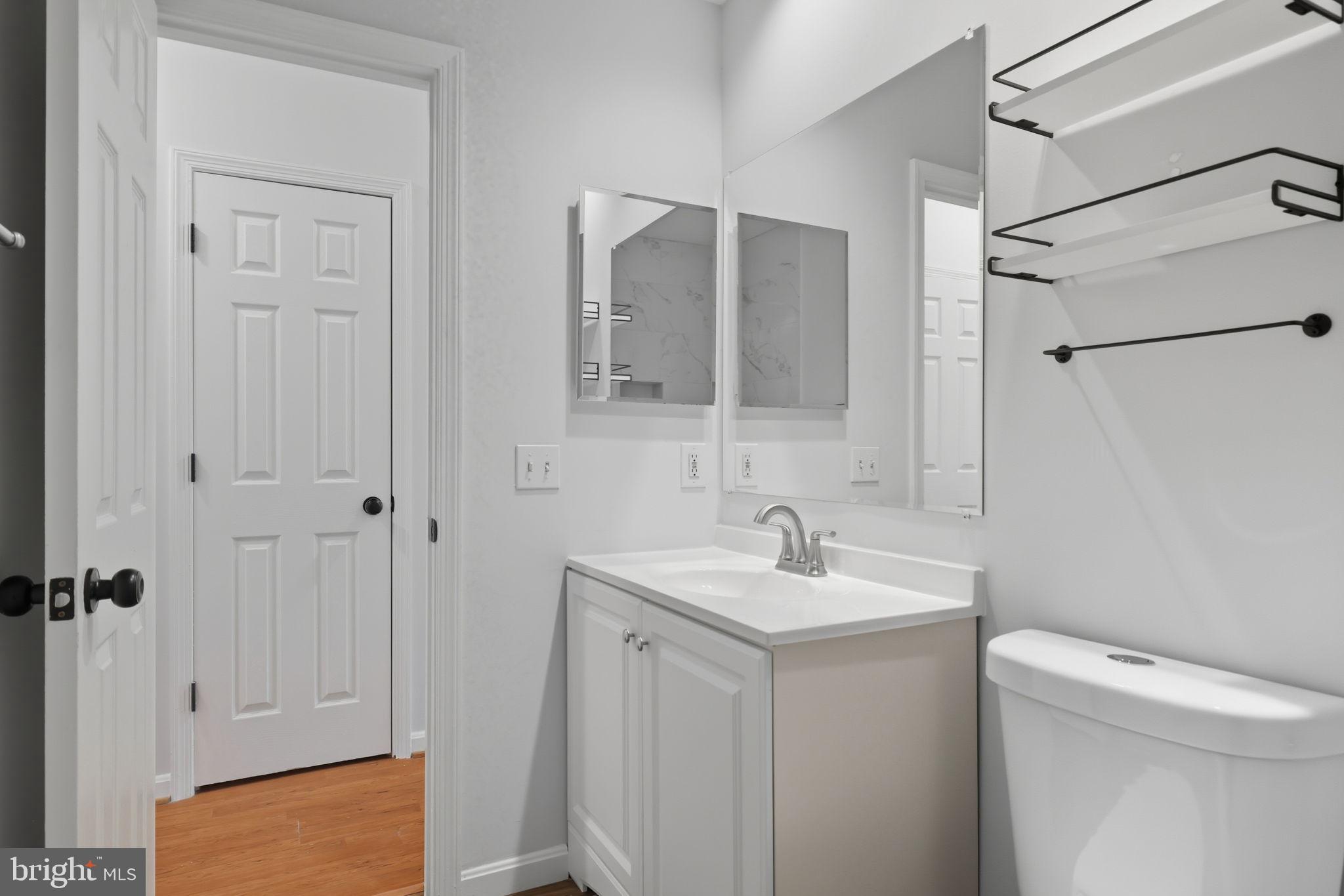 1340 Garden Wall Circle, Unit 502 Reston, VA 20194 - Photo 23 of 32 a bathroom with a sink a toilet and shower