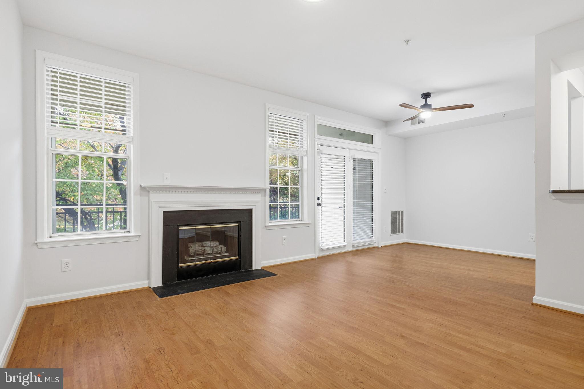 1340 Garden Wall Circle, Unit 502 Reston, VA 20194 - Photo 10 of 32 a view of an empty room with a fireplace and a window