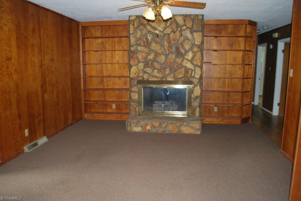 412 Summit Road High Point, NC 27265 - Photo 4 of 10 Den with fireplace and built-in shelves. Glass doors to patio are off from the den on the left.