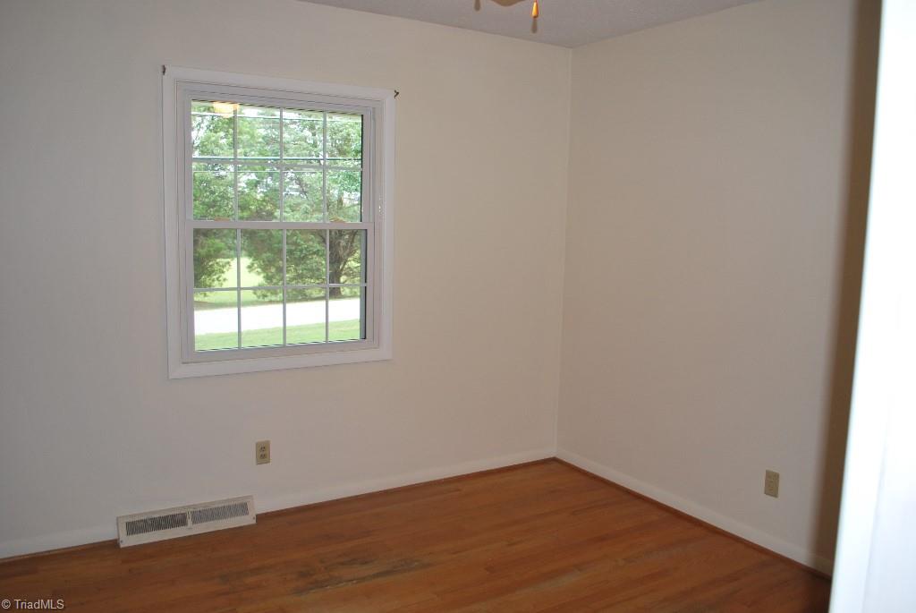 412 Summit Road High Point, NC 27265 - Photo 8 of 10 Second bedroom and third bedroom are close in size and also have hardwood flooring.