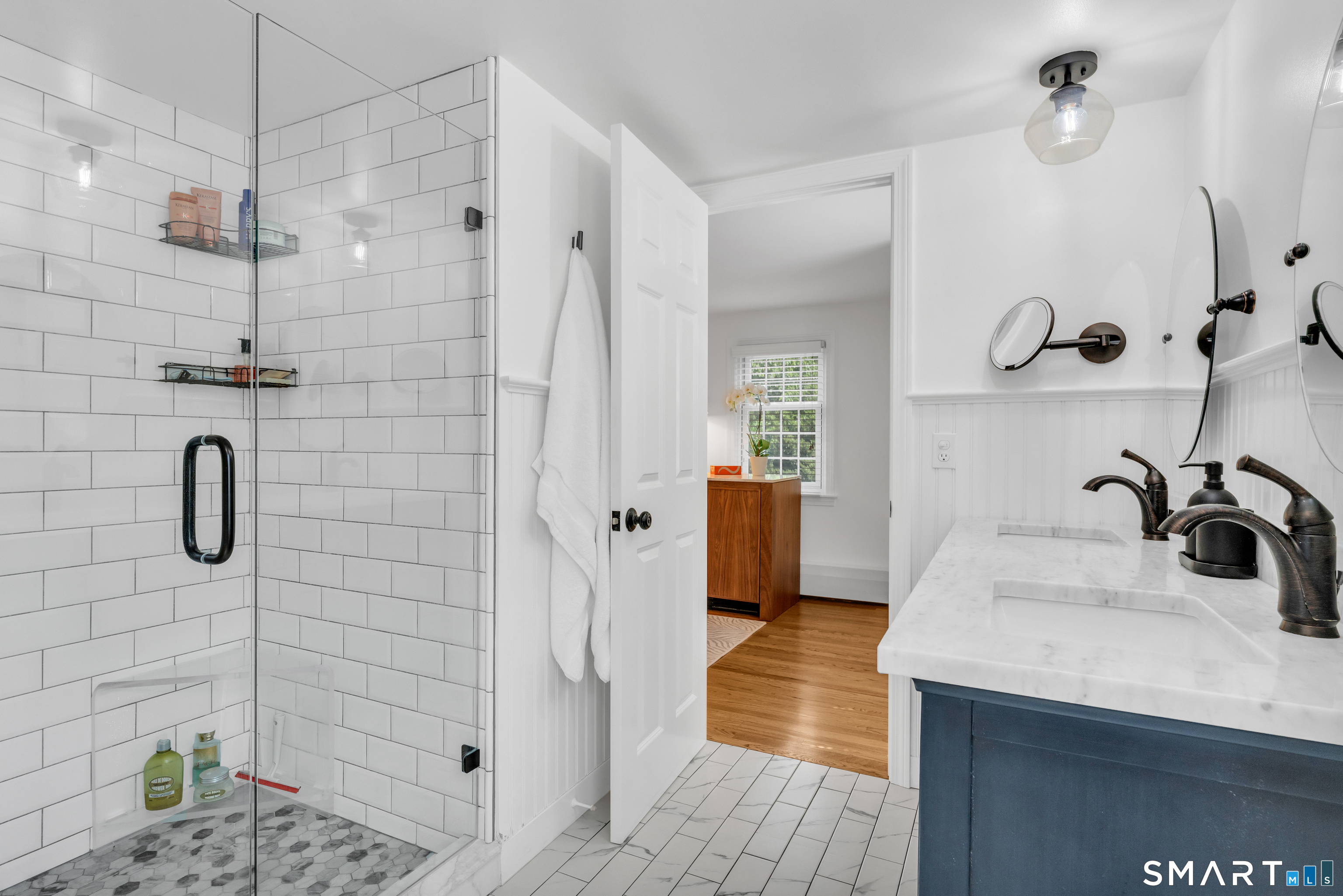 33 River Edge Farms Road Madison, CT 06443 - Photo 24 of 40 Double sinks and a large walk-in shower highlight the balance between luxurious comfort and functional efficiency.