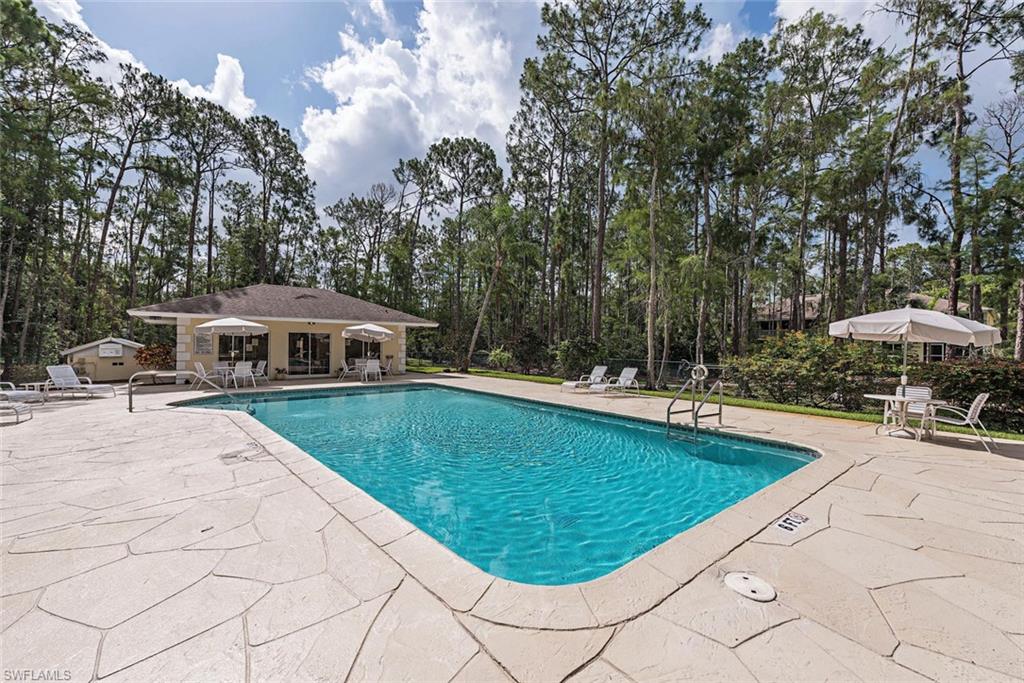 3451 County Barn Road, Unit G204 Naples, FL 34112 - Photo 11 of 12 a view of a swimming pool with an outdoor seating