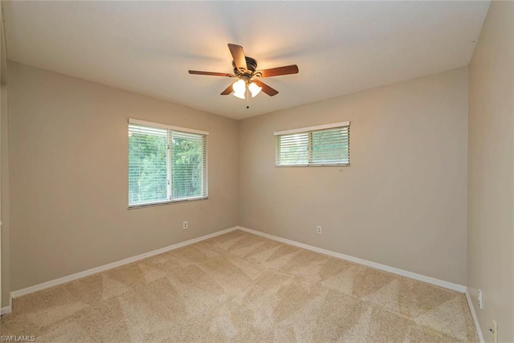 3451 County Barn Road, Unit G204 Naples, FL 34112 - Photo 8 of 12 an empty room with windows and fan