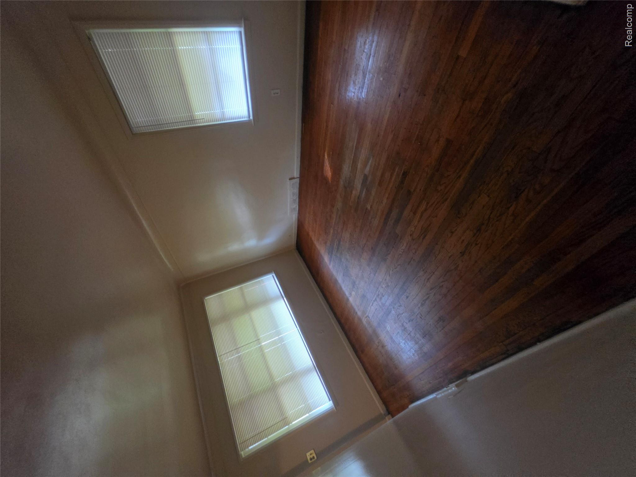 18539 Lahser Road Detroit, MI 48219 - Photo 2 of 23 Hardwood flooring, painted walls, and window treatments