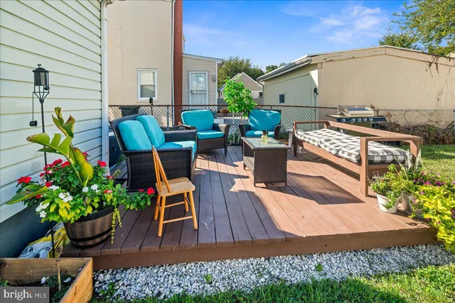 a view of a chairs and table in the backyard