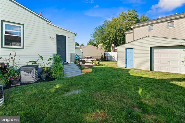 a front view of a house with a garden and plants