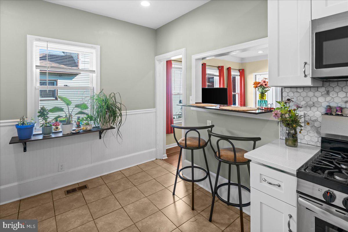 48 Homestead Avenue Ewing, NJ 08638 - Photo 8 of 21 a kitchen with stainless steel appliances kitchen island granite countertop a table and chairs in it