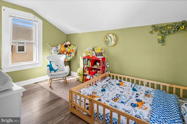 a living room with furniture and paintings on the wall