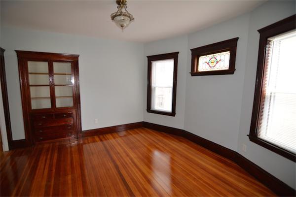 104 King Street, Unit 2 Boston, MA 02122 - Photo 11 of 29 wooden floor in an empty room with a window
